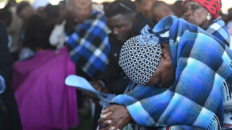 Mourners attend a mass funeral in Molepololefor, Gaborone, Botswana, Saturday...