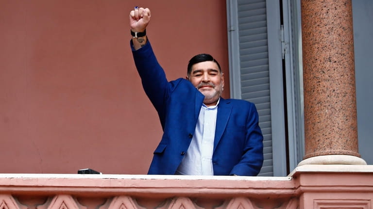 Former soccer great Diego Maradona acknowledges fans below at the...