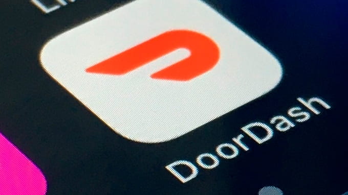 The DoorDash app is shown on a smartphone on Feb....