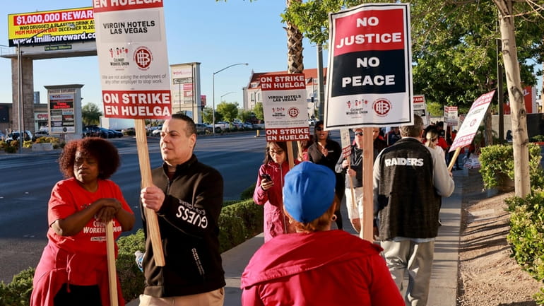 Culinary Local 226 members picket at the start of a...