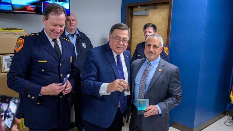 Robert Waring, acting Suffolk police commissioner, left, County Executive Edward P. Romaine and...