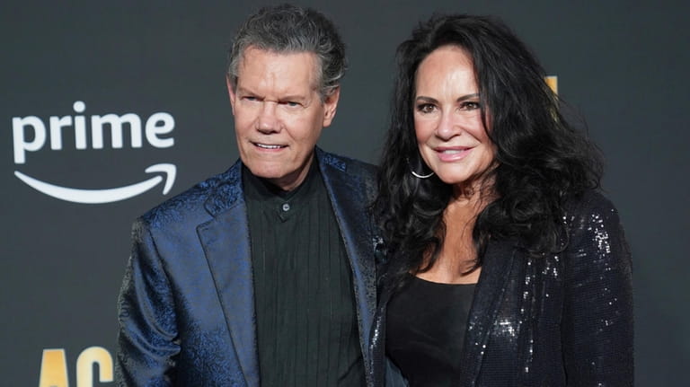 Randy Travis, left, and Mary Davis appear at the 58th...