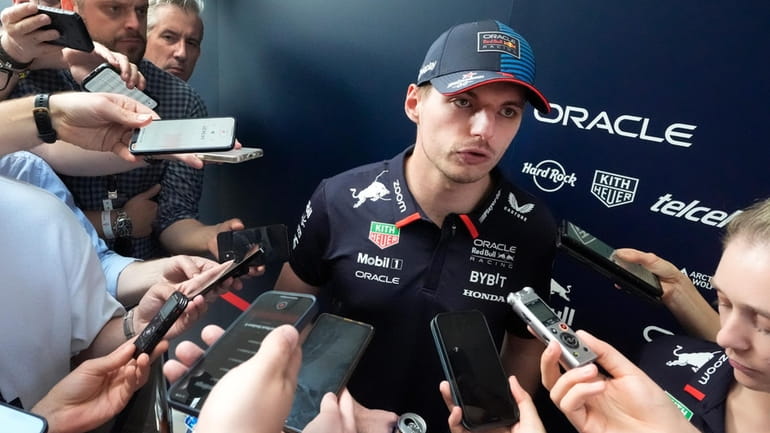 Red Bull driver Max Verstappen speaks to members of the...
