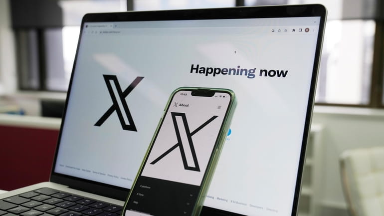 The opening page of X is displayed on a computer...