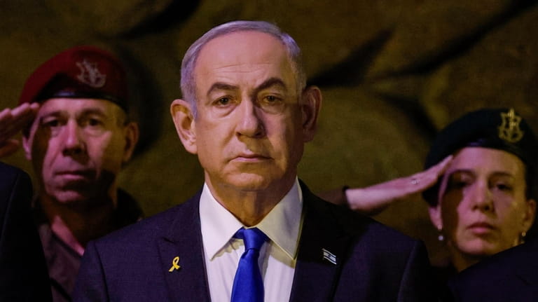 Israeli Prime Minister Benjamin Netanyahu, front, attends a wreath-laying ceremony...