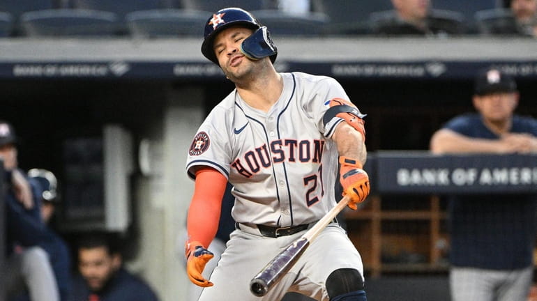 Houston Astros’ Jose Altuve reacts after striking out swinging against...