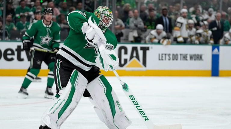 Dallas Stars goaltender Jake Oettinger clears the puck in the...