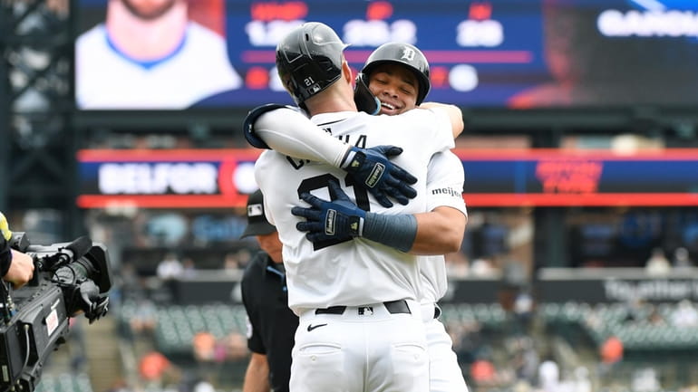 Detroit Tigers' Wenceel Pérez, right, is hugged by Mark Canha,...