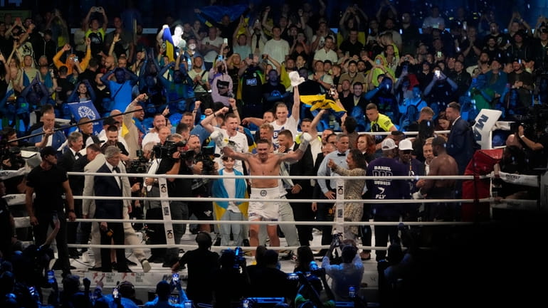 Ukraine's Oleksandr Usyk celebrates after beating Britain's Daniel Dubois during...