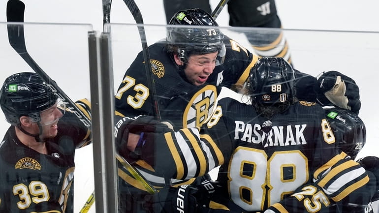 Boston Bruins' David Pastrnak (88) celebrates his goal with Morgan...