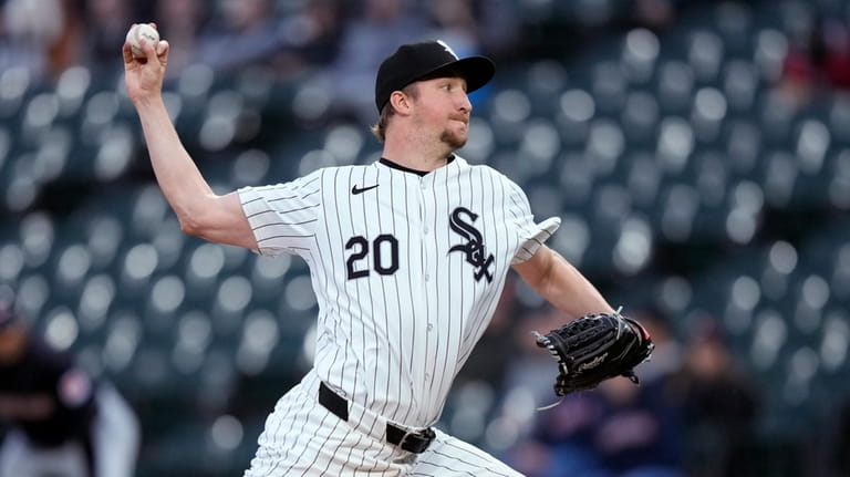 Chicago White Sox starting pitcher Erick Fedde delivers to a...