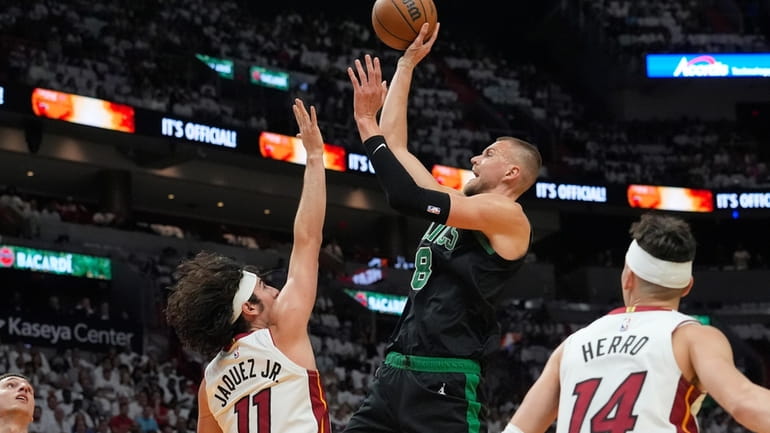 Boston Celtics center Kristaps Porzingis (8) aims to score as...