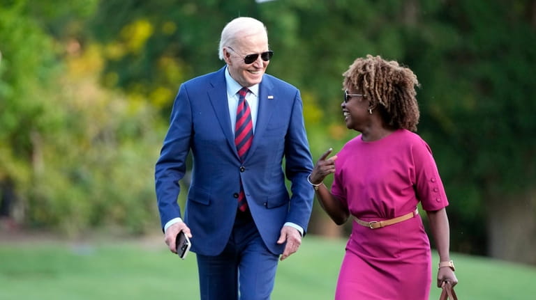 President Joe Biden walks across the South Lawn of the...