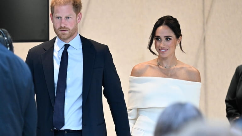 Britain's Prince Harry, The Duke of Sussex, left, and Meghan,...