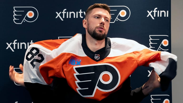 Philadelphia Flyers' Ivan Fedotov puts on his new Flyers jersey...
