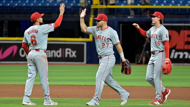 Los Angeles Angels' Anthony Rendon (6), Mike Trout (27) and...
