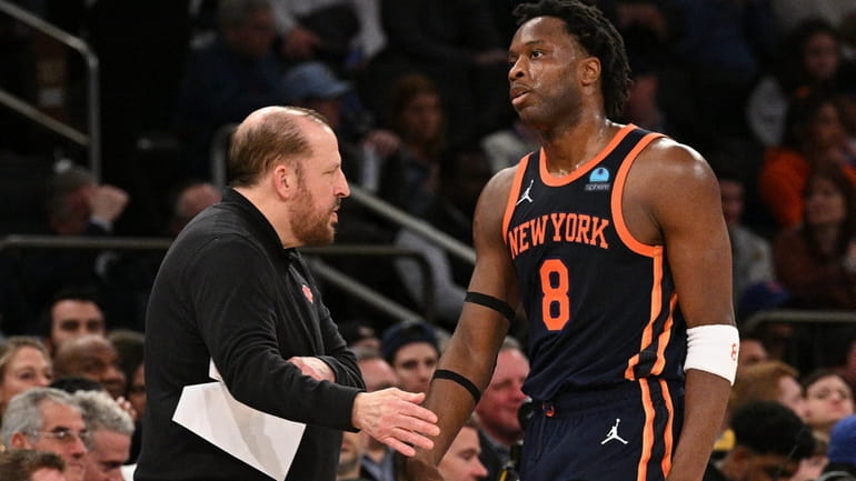 New York Knicks head coach Tom Thibodeau slaps five with...
