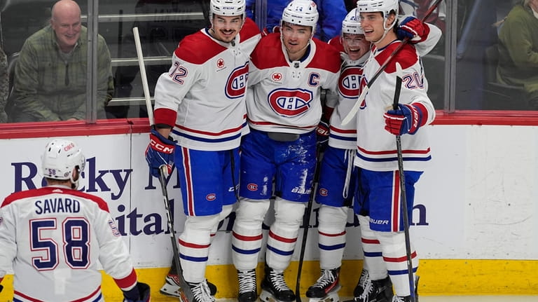 Montreal Canadiens defenseman David Savard, left, heads over to congratulate...