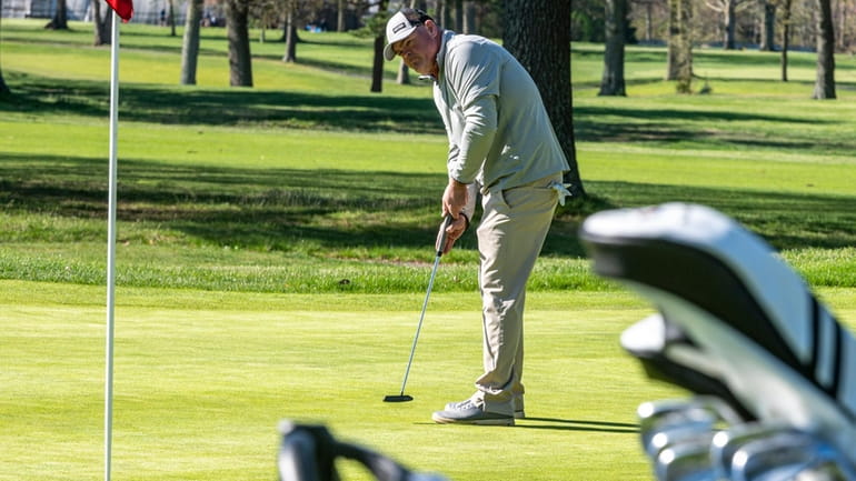 A golfer putts at one of the Bethpage State Park courses.