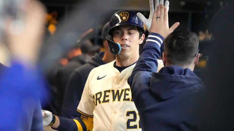 Milwaukee Brewers outfielder Christian Yelich celebrates after hitting a home...