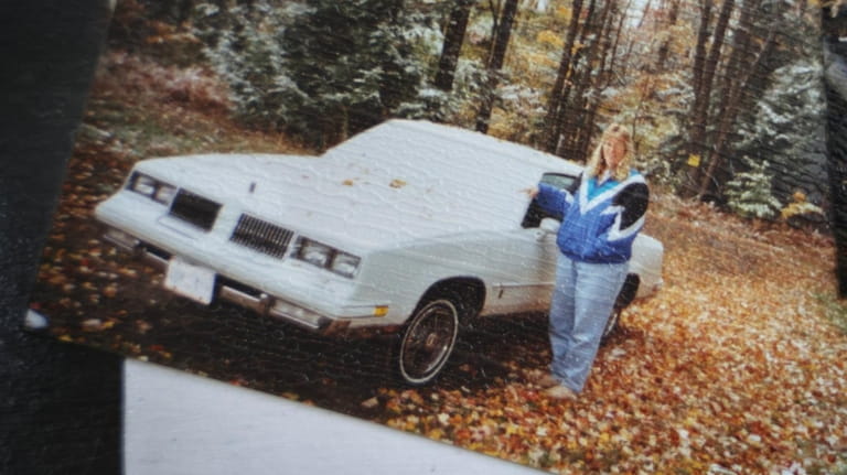 Nancy Urban next to her 1983 Oldsmobile Cutlass in the...