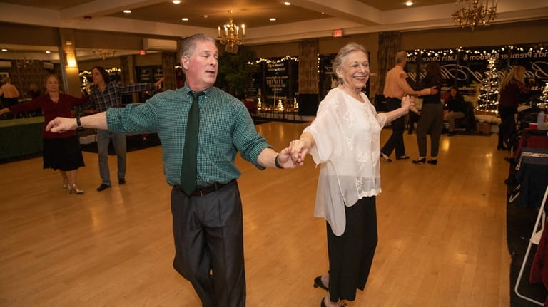Instructor George Smith, left, and Judith Margolin from Melville dance...