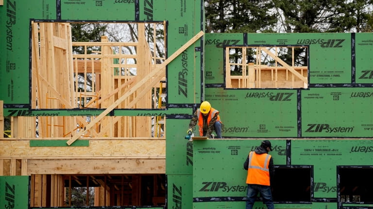 New homes are shown under construction in Mount Prospect, Ill.,...