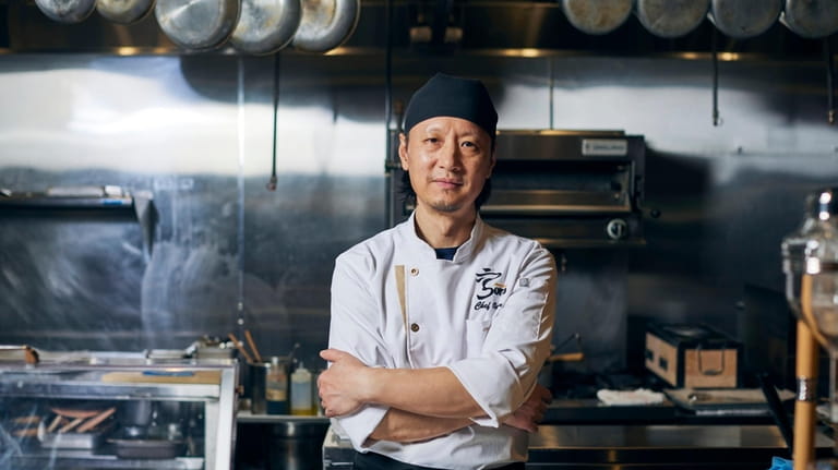 Chef Osan prepares fresh raw fish at Sora Omakase in...