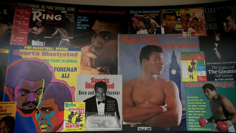 Large posters of mostly Sports Illustrated magazine covers are displayed...