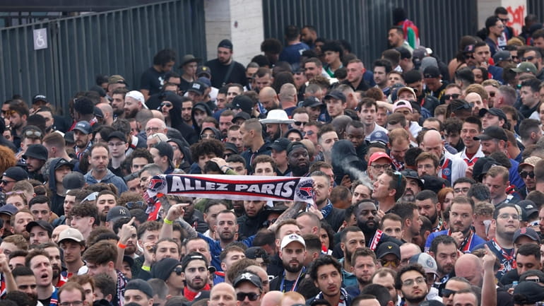 Paris Saint-Germain supporters arrive at the Olimpic Lluis Companys stadium...