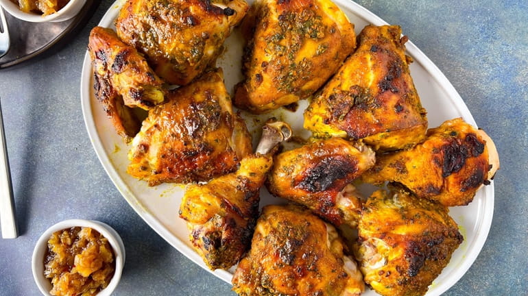 Chicken is roasted with a paste of turmeric and other...