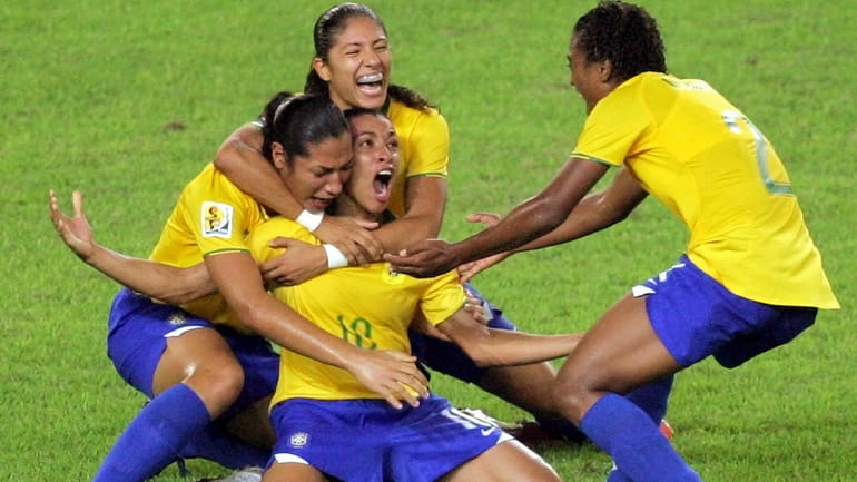 Brazil's Marta, center, celebrates her goal against the United States...