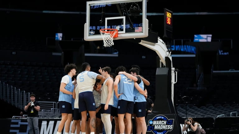 North Carolina players huddle during practice ahead of their Sweet...