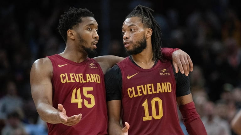 Cleveland Cavaliers' Donovan Mitchell (45) and Darius Garland (10) talk...