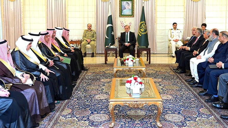 In this photo released by Prime Minister Office, visiting Saudi...