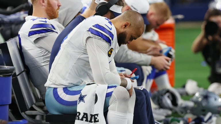 Dak Prescott of the Cowboys sits on the bench during the...