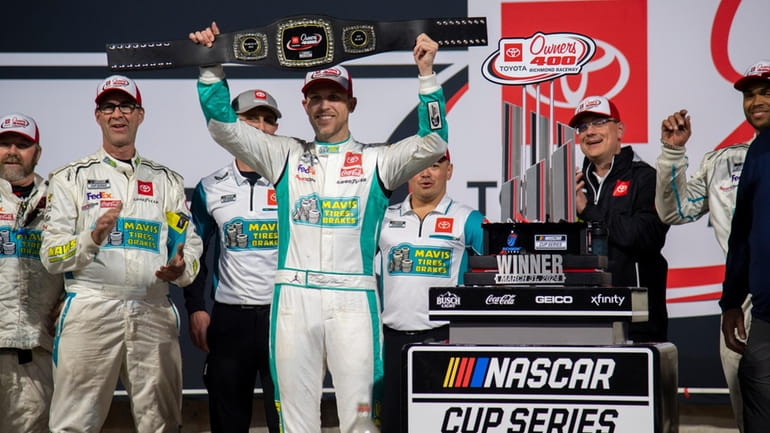 Denny Hamlin celebrates after winning a NASCAR Cup Series auto...