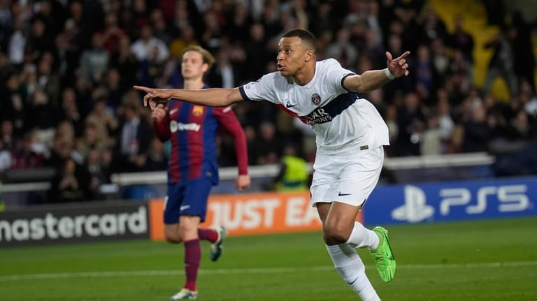 PSG's Kylian Mbappe celebrates after scoring his side's third goal...