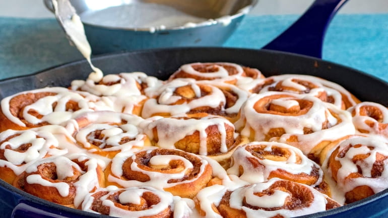 Cinnamon buns baked in a skillet with buttermilk glaze. (December...
