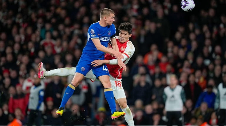 Chelsea's Alfie Gilchrist, left, jumps for the ball with Arsenal's...