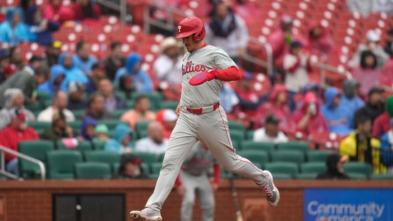 Philadelphia Phillies' J.T. Realmuto scores during the sixth inning of...