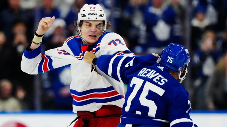 The Rangers' Matt Rempe and the Maple Leafs' Ryan Reaves fight...