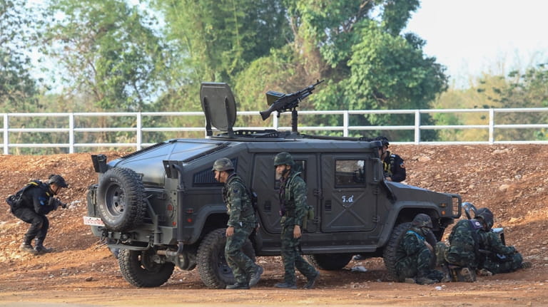 A Thai military armored vehicle takes a position with sounds...