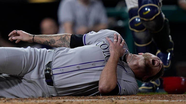 Colorado Rockies' Kyle Freeland reacts after being tagged out at...