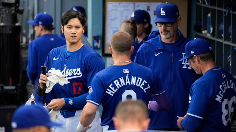 Los Angeles Dodgers' Shohei Ohtani (17) walks across the dugout...