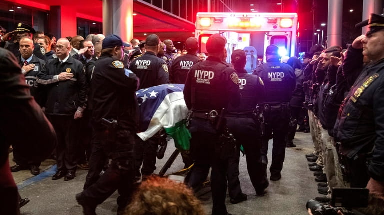 The body of NYPD Officer Jonathan Diller is removed from...