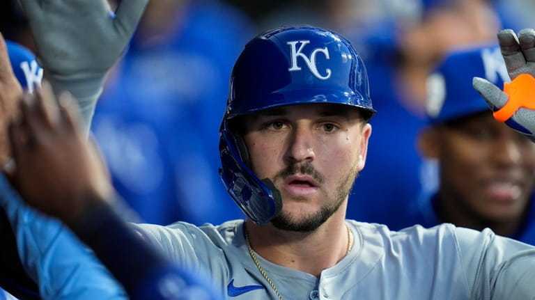 Kansas City Royals' Vinnie Pasquantino celebrates in the dugout after...