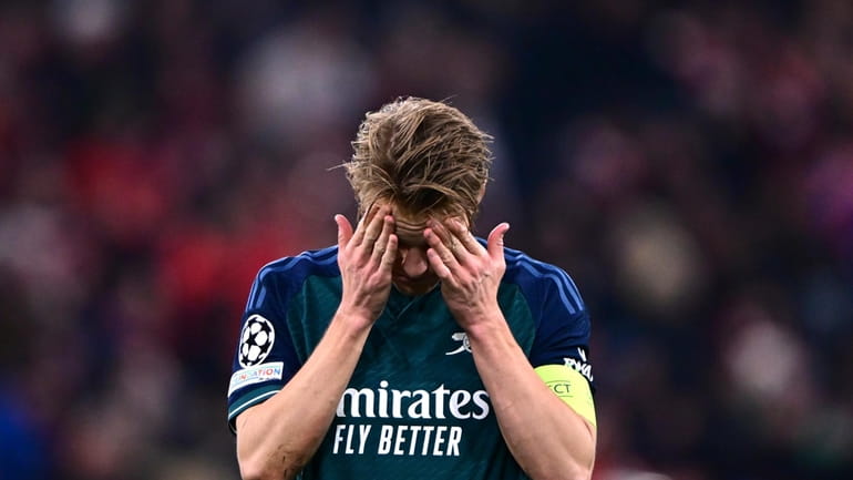 Arsenal's Martin Odegaard reacts disappointed after the Champions League quarter...