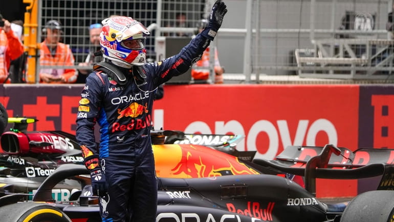 Red Bull driver Max Verstappen of the Netherlands waves after...