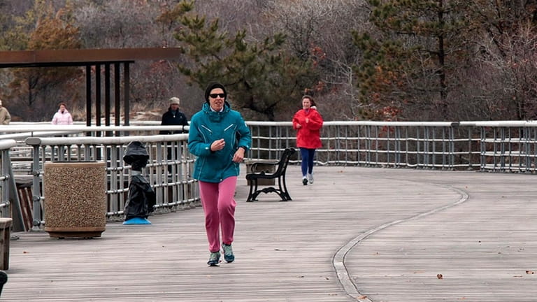 Joggers and walkers get their exercise along the boardwalk at...